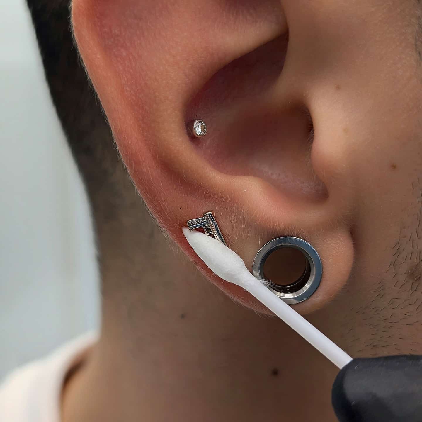 DRY. Grab a dry cotton bud/q-tip and dry the piercing and area around. It’s important to dry your piercings just as well as we clean them! Piercings don’t like moisture, and not drying your piercings properly can lead to irritation bumps or piercing bumps.